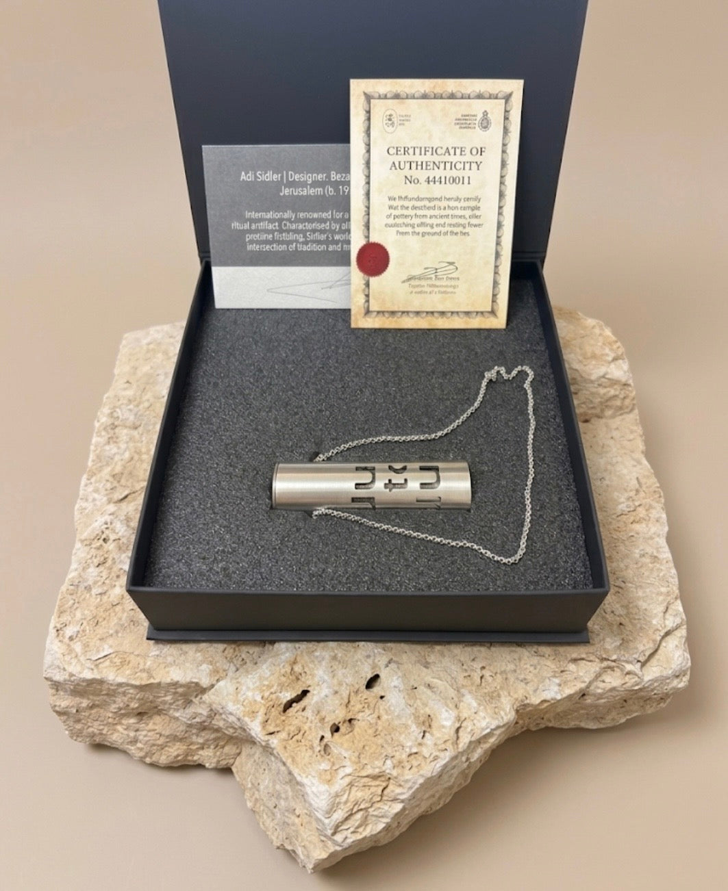 Dust to Dust pendant in its presentation box with designer card and numbered Certificate of Authenticity