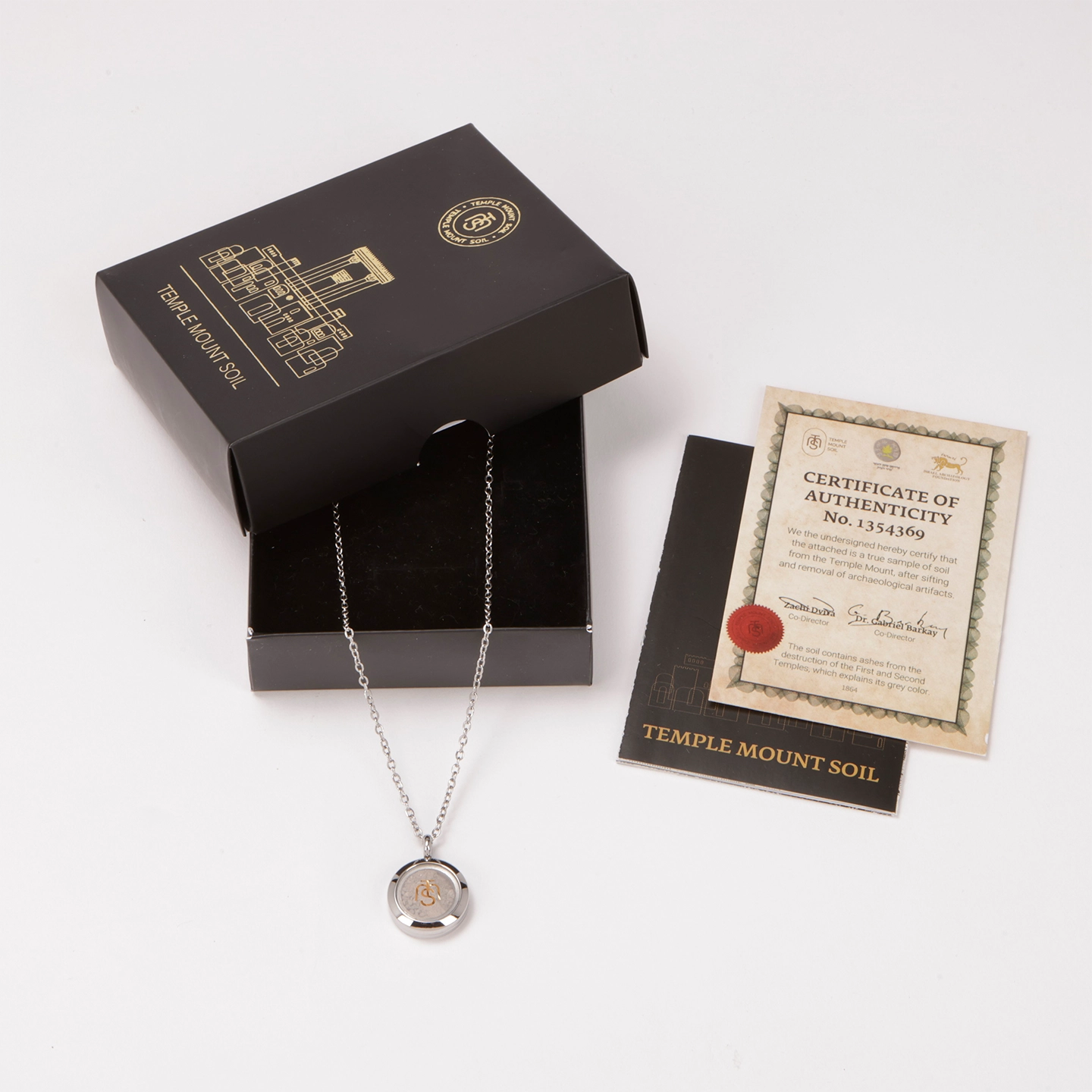 The Locket of Divine Promise in silver with its black Temple Mount Soil gift box and numbered Certificate of Authenticity