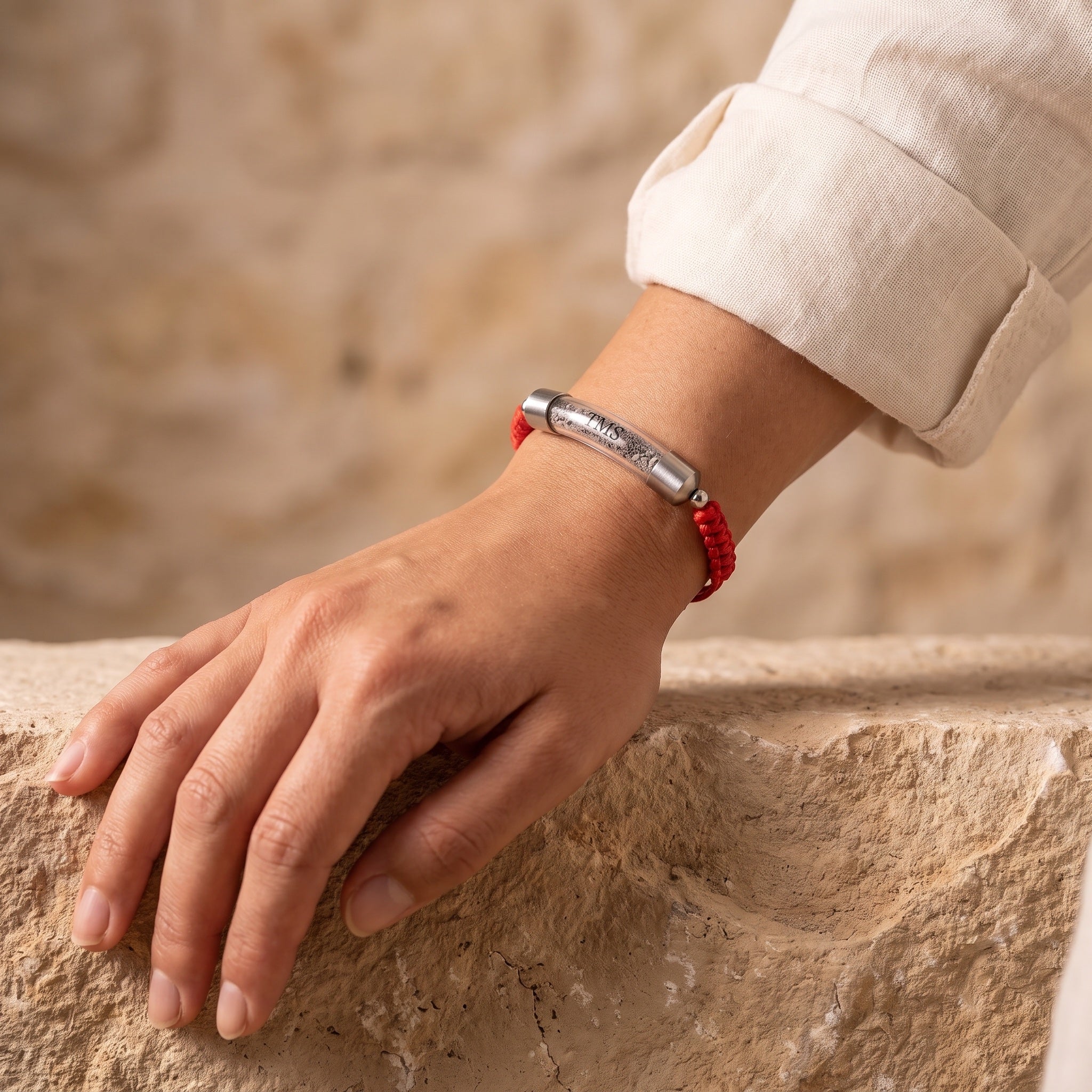 Red Covenant Soil Bracelet worn on a woman's wrist