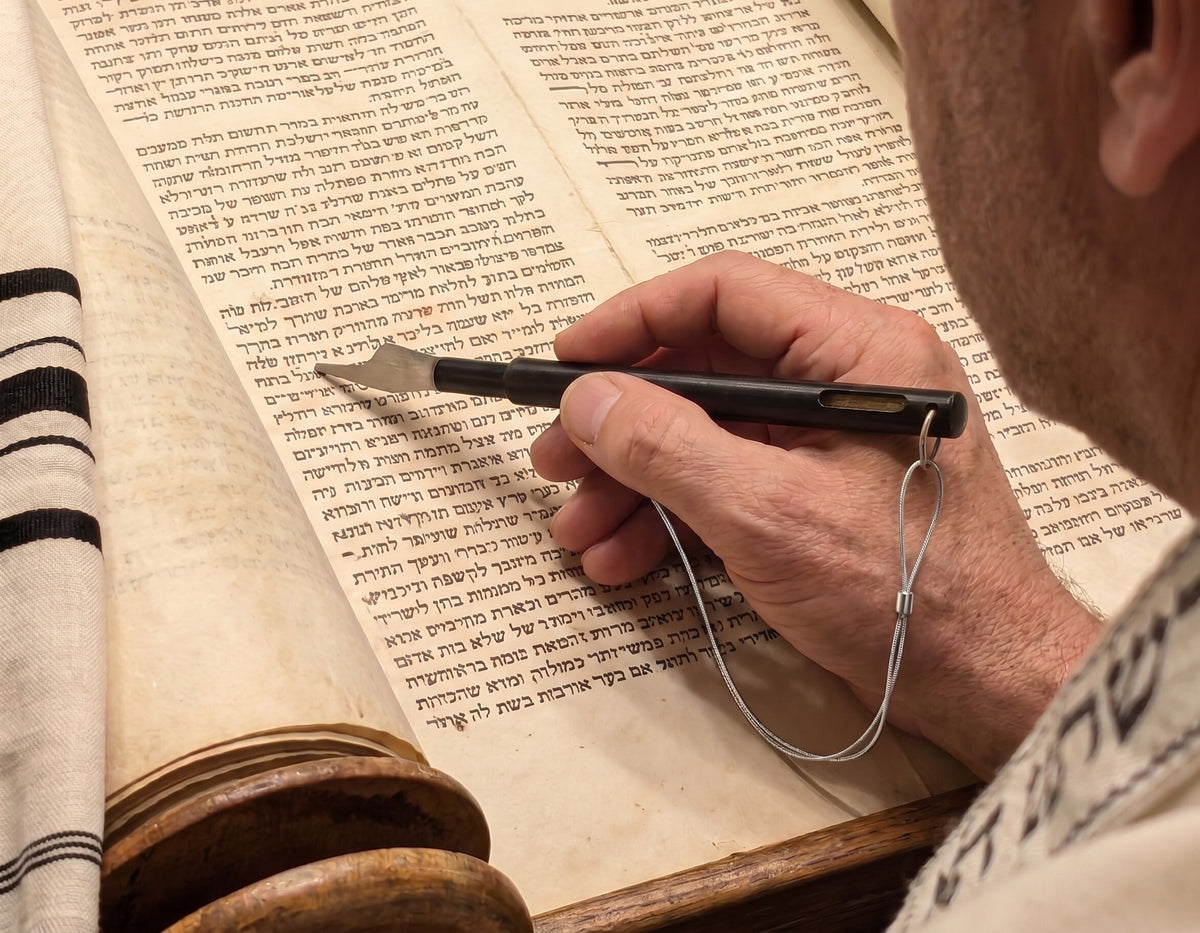Reading the Torah with The Hand of the Scroll, the silver tip following the text