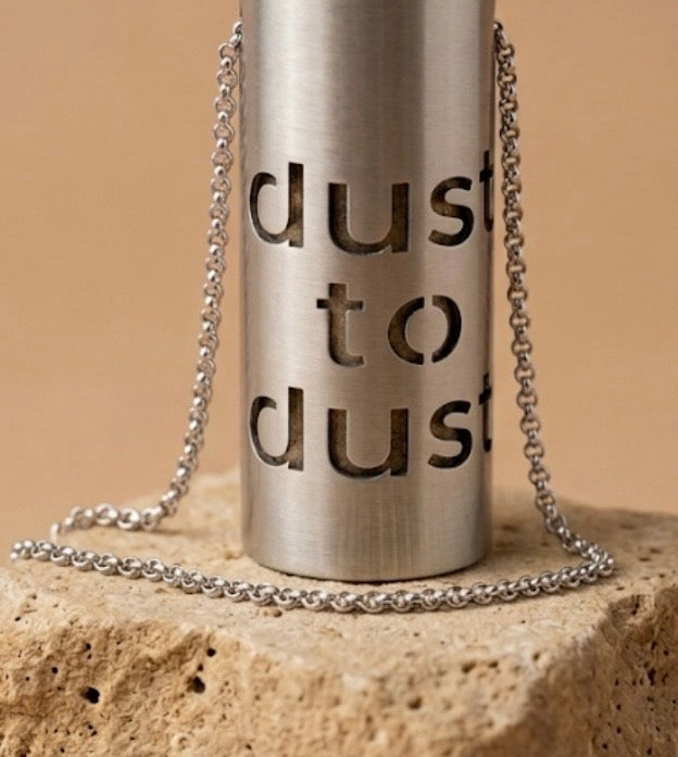 Close view of the words dust to dust cut through the brushed steel