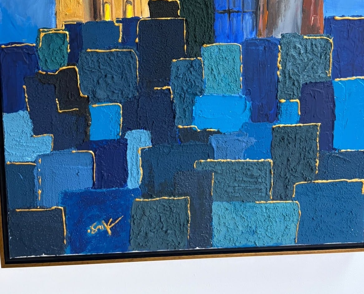 Detail of the sand-textured stone squares edged in gold