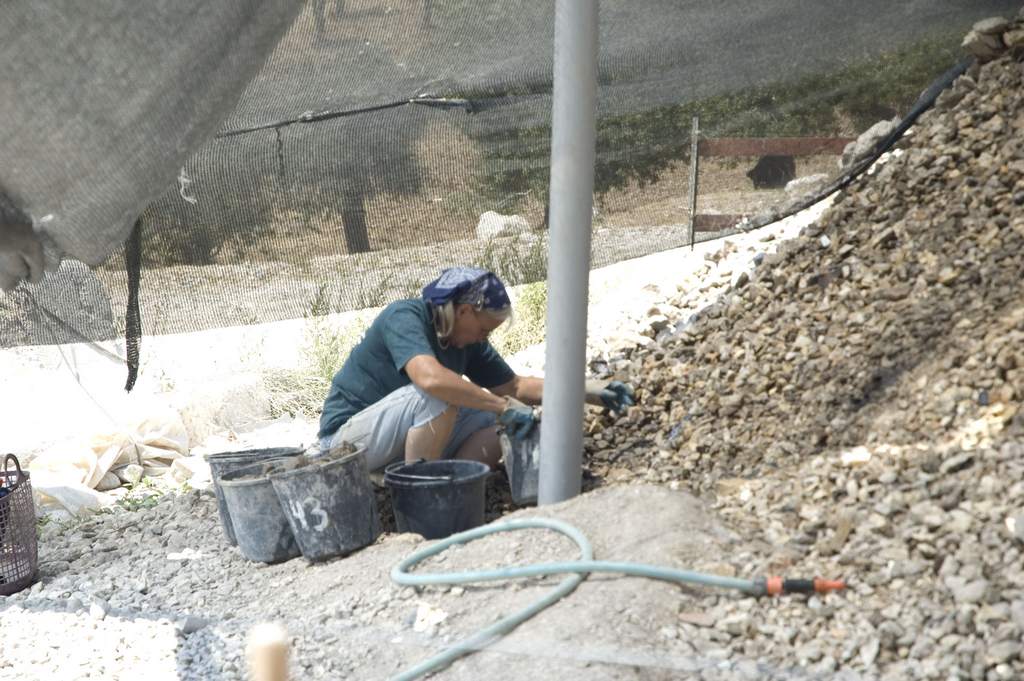 Soil heaps and hose at the early sifting site